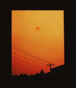 Wildfire smoke damage in your home shown as orange haze over a Los Angeles neighborhood